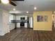 Modern kitchen with stainless steel appliances, white cabinets, and decorative backsplash at 1721 Nebraska Loop, Sumterville, FL 33585