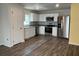 Modern kitchen with stainless steel appliances, white cabinets, and ample counter space at 1721 Nebraska Loop, Sumterville, FL 33585