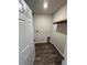 Laundry room with wood-style flooring and utility connections at 1721 Nebraska Loop, Sumterville, FL 33585