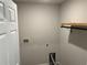 Laundry room with a utility hookup and shelving unit at 1721 Nebraska Loop, Sumterville, FL 33585