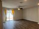 Bright living room featuring wood-look flooring and sliding glass doors to the outdoor patio at 1721 Nebraska Loop, Sumterville, FL 33585