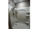 Shower stall featuring a rainfall showerhead and built-in shelving for toiletries at 1721 Nebraska Loop, Sumterville, FL 33585