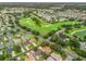 Aerial view of a community with a golf course in the background, property location outlined in red at 17349 Se 76Th Flintlock Ter, The Villages, FL 32162
