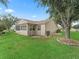 Home exterior showing a stone mulch bed and sunroom at 17349 Se 76Th Flintlock Ter, The Villages, FL 32162