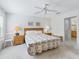Comfortable bedroom with ceiling fan and two bedside tables with lamps at 17349 Se 76Th Flintlock Ter, The Villages, FL 32162