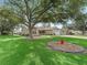 A beautiful home with a large tree in the front yard providing shade and enhancing curb appeal at 17349 Se 76Th Flintlock Ter, The Villages, FL 32162