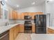 Kitchen features stainless steel appliances, white countertops and light wood cabinets at 17349 Se 76Th Flintlock Ter, The Villages, FL 32162