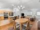 Bright living room featuring dining area, kitchen, and hardwood floors at 17349 Se 76Th Flintlock Ter, The Villages, FL 32162