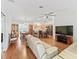 Spacious living area with hardwood floors seamlessly flowing into the dining and kitchen areas at 17349 Se 76Th Flintlock Ter, The Villages, FL 32162