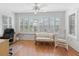 Bright office featuring large windows with shutters and hardwood flooring at 17349 Se 76Th Flintlock Ter, The Villages, FL 32162