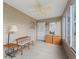 Sunroom featuring a bench, many windows, and a ceiling fan at 17349 Se 76Th Flintlock Ter, The Villages, FL 32162