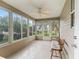 Relaxing sunroom featuring a bench, many windows, and a ceiling fan at 17349 Se 76Th Flintlock Ter, The Villages, FL 32162