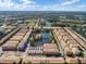 Aerial view of the community with a body of water, fountain, bridge, mature trees and townhomes at 1795 Piedmont Pl, Lake Mary, FL 32746