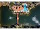 Aerial view of a community pool, clubhouse, pond and fountains surrounded by mature landscaping at 1795 Piedmont Pl, Lake Mary, FL 32746