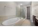 Bright bathroom featuring a soaking tub, glass shower, and neutral tile at 1795 Piedmont Pl, Lake Mary, FL 32746