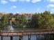 Beautiful condo community featuring a lake view with a fountain, lush trees and blue skies at 1795 Piedmont Pl, Lake Mary, FL 32746