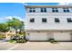 Townhome featuring a two car garage, light gray exterior paint and a landscaped corner at 1795 Piedmont Pl, Lake Mary, FL 32746