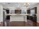 Spacious kitchen with a large island, granite countertops, stainless appliances, and rich dark wood cabinets at 1795 Piedmont Pl, Lake Mary, FL 32746