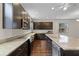 Modern kitchen with granite countertops, stainless steel appliances, dark cabinetry, and hardwood flooring at 1795 Piedmont Pl, Lake Mary, FL 32746