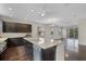 Spacious kitchen with granite island, stainless steel appliances, dark cabinets, and view to the living area at 1795 Piedmont Pl, Lake Mary, FL 32746
