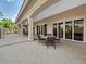 Covered patio features neutral colors, a ceiling fan, outdoor lighting and a circular table with four chairs at 1795 Piedmont Pl, Lake Mary, FL 32746
