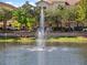 Community pond featuring a fountain and surrounding residential buildings in the background at 1795 Piedmont Pl, Lake Mary, FL 32746