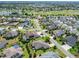 Scenic aerial view of a residential community with a golf course, lake, and well-maintained landscaping at 1842 Lake Ridge Dr, The Villages, FL 32162