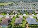 Residential community featuring well-kept homes, lush landscaping, and recreational facilities, a golf course in the distance at 1842 Lake Ridge Dr, The Villages, FL 32162