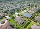 Neighborhood showcasing well-maintained homes with lush landscaping and mature trees, near a quiet street at 1842 Lake Ridge Dr, The Villages, FL 32162