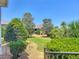 Exterior shot of meticulously landscaped backyard with healthy green foliage and stone walking path, offering tranquil views at 1842 Lake Ridge Dr, The Villages, FL 32162