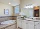 Bright bathroom features a soaking tub and vanity with granite countertops at 1842 Lake Ridge Dr, The Villages, FL 32162