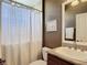 Bathroom with single sink vanity, framed mirror and shower with curtain at 1842 Lake Ridge Dr, The Villages, FL 32162