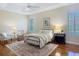Comfortable bedroom with ceiling fan, accent rug, sitting area, and natural light at 1842 Lake Ridge Dr, The Villages, FL 32162