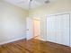 Bright bedroom features wood floors and large closets for ample storage at 1842 Lake Ridge Dr, The Villages, FL 32162