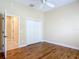 Bedroom with wood floors, open doorway and closet at 1842 Lake Ridge Dr, The Villages, FL 32162