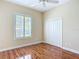 Comfortable bedroom featuring wood floors, large window and closet at 1842 Lake Ridge Dr, The Villages, FL 32162