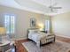 Well-lit bedroom with ceiling fan, accent rug, and sitting area at 1842 Lake Ridge Dr, The Villages, FL 32162
