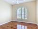 Bright bedroom with wood floors, large window with shutters at 1842 Lake Ridge Dr, The Villages, FL 32162