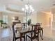 Bright dining room with decorative ceiling and chandelier, opens to the living room at 1842 Lake Ridge Dr, The Villages, FL 32162