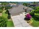 Lovely single-story home featuring a well-manicured lawn, neutral paint scheme, and a spacious driveway and attached garage at 1842 Lake Ridge Dr, The Villages, FL 32162