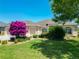 Charming home with well-maintained lawn, colorful landscaping, and inviting curb appeal at 1842 Lake Ridge Dr, The Villages, FL 32162