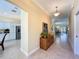 Bright hallway with access to the kitchen, dining room, and living area, complemented by stylish décor and tile floors at 1842 Lake Ridge Dr, The Villages, FL 32162