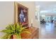 Hallway featuring a decorative painting and offering a glimpse into the dining and living room areas at 1842 Lake Ridge Dr, The Villages, FL 32162