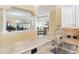 View from the kitchen featuring granite countertop and stainless steel sink looking to dining and living rooms at 1842 Lake Ridge Dr, The Villages, FL 32162