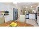 Bright open kitchen with white cabinets, stainless steel appliances, and tile flooring at 1842 Lake Ridge Dr, The Villages, FL 32162
