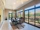 View of outdoor lanai with patio set and picturesque view of greenery, with floor to ceiling windows at 1842 Lake Ridge Dr, The Villages, FL 32162