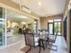 View of lanai featuring tile floors, an outdoor dining set, ceiling fan, and view into the interior at 1842 Lake Ridge Dr, The Villages, FL 32162