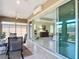 View from tiled lanai through sliding glass doors into the living room and other parts of the home at 1842 Lake Ridge Dr, The Villages, FL 32162