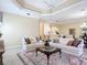 Bright living room featuring neutral walls, tile floor, and comfortable seating at 1842 Lake Ridge Dr, The Villages, FL 32162