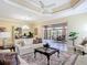 Inviting living room with neutral decor leading to an outdoor seating area at 1842 Lake Ridge Dr, The Villages, FL 32162